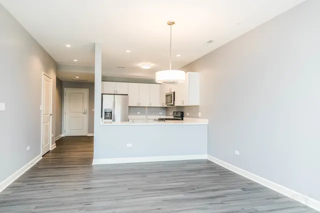 a view of a kitchen with wooden floor