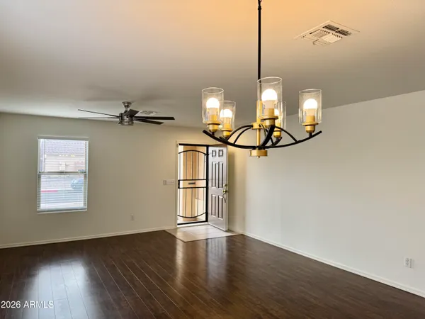 a view of a room with wooden floor and windows