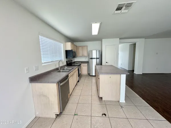 a kitchen with a stove a sink and a refrigerator