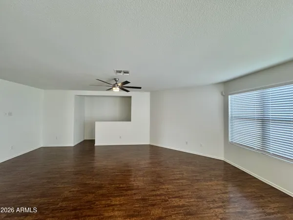 a view of a room with wooden floor and a window