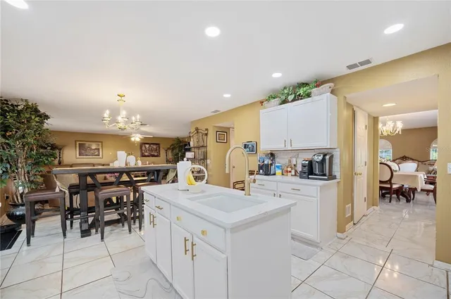 a kitchen with cabinets and chairs