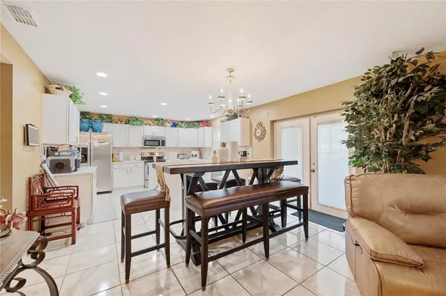 a living room with furniture a flat screen tv and a window