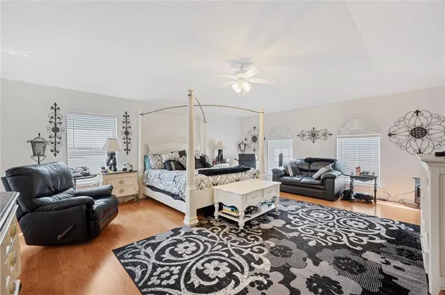 a bedroom with furniture and wooden floor