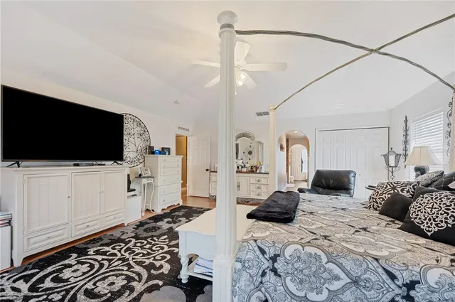 a view of a hallway with windows and wooden door
