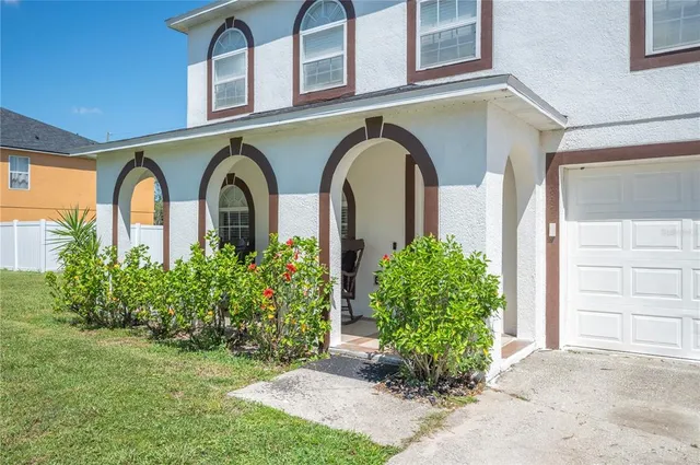 a front view of a house with garden