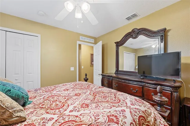 a bedroom with a bed window and dresser