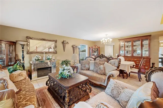 a living room with furniture fireplace and a large window