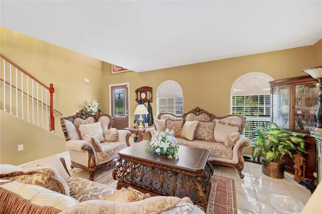 a living room with furniture fireplace and potted plants