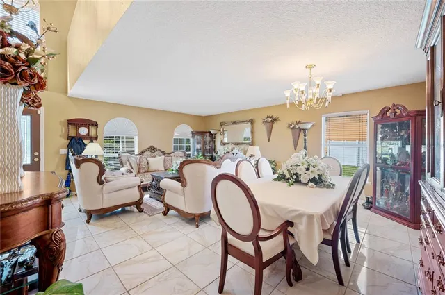 a view of a dining room with furniture and chandelier