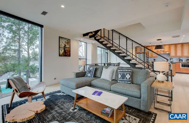 a living room with furniture and a book shelf