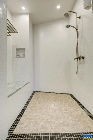 a spacious bathroom with a toilet sink and mirror