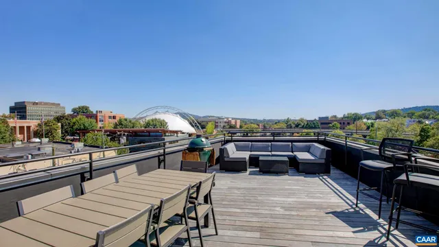 a terrace with outdoor seating and city view