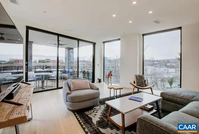 a living room with furniture and a floor to ceiling window