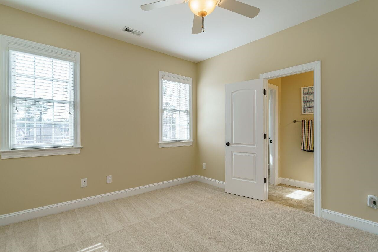5327 Landguard Drive Raleigh, NC 27613 - Photo 30 of 45 Another great upstairs bedroom with fan, wooden shelving in closet and new carpet! Bedroom