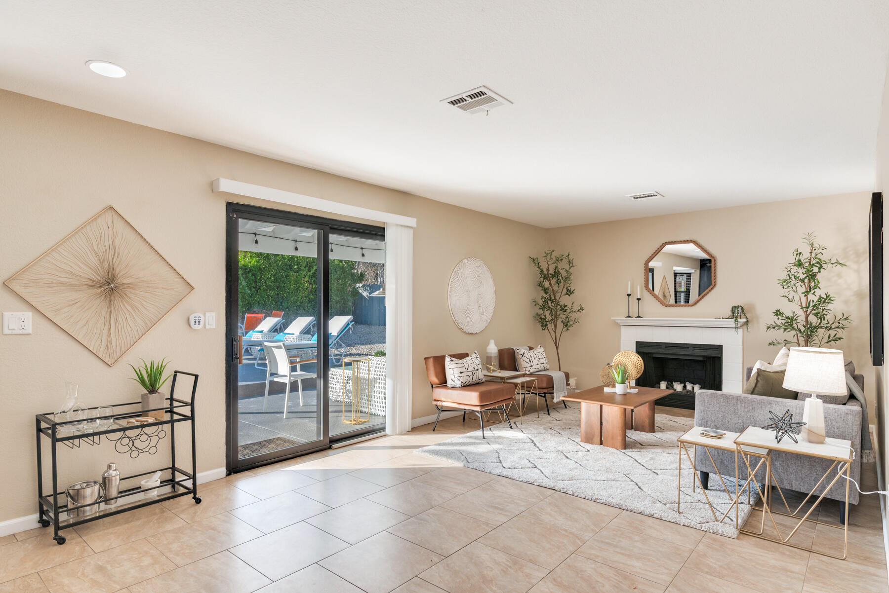 2003 North Sandra Road Palm Springs, CA 92262 - Photo 12 of 25 a living room with furniture a fireplace and a floor to ceiling window