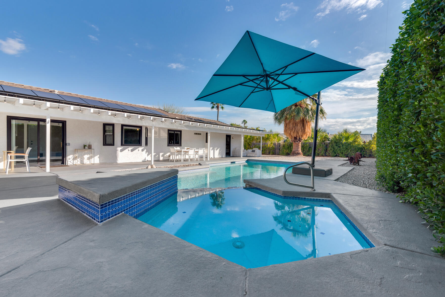 2003 North Sandra Road Palm Springs, CA 92262 - Photo 3 of 25 a view of a patio with a table and chairs under an umbrella