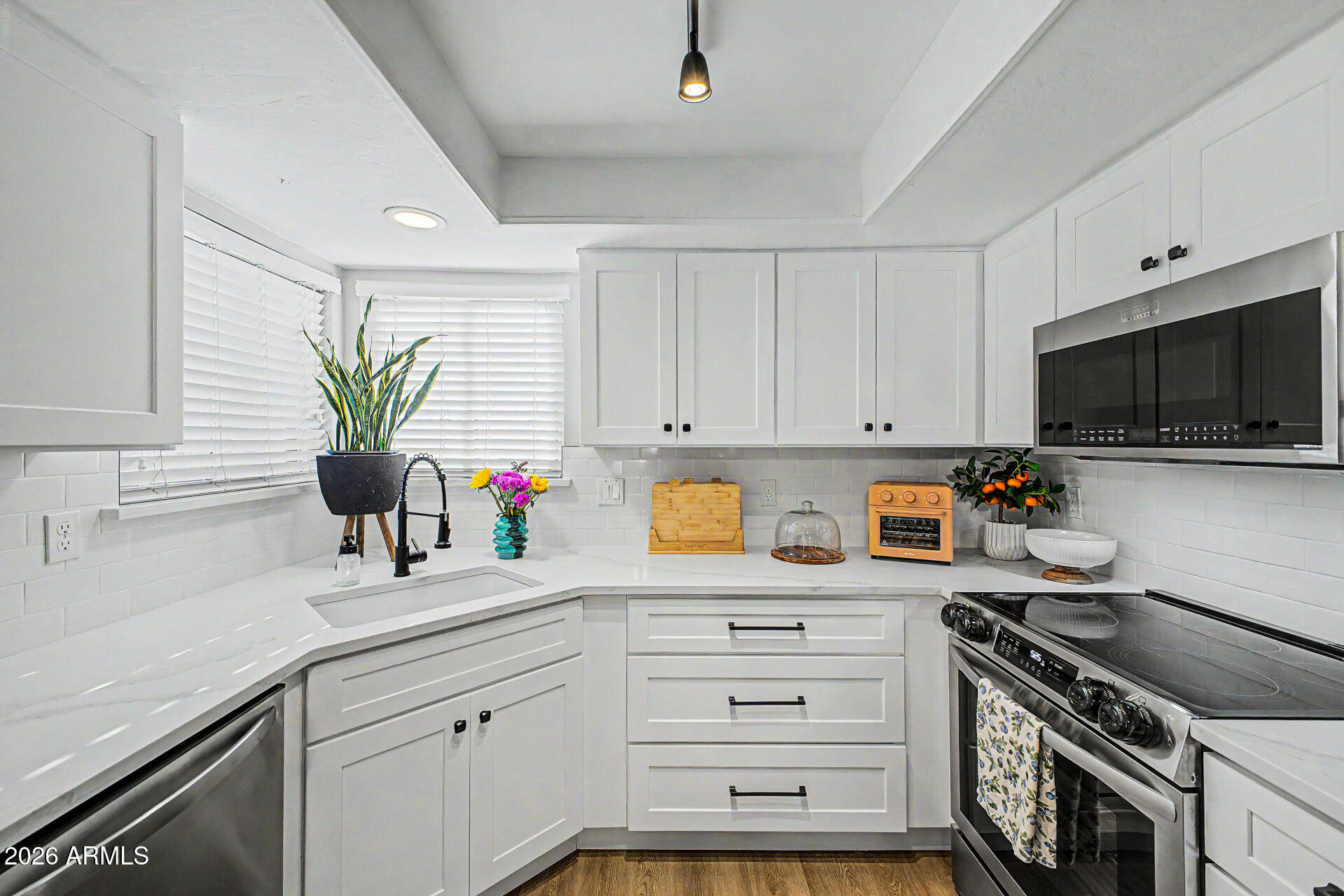 2455 East Broadway Road, Unit 65 Mesa, AZ 85204 - Photo 11 of 36 a kitchen with appliances a sink and cabinets