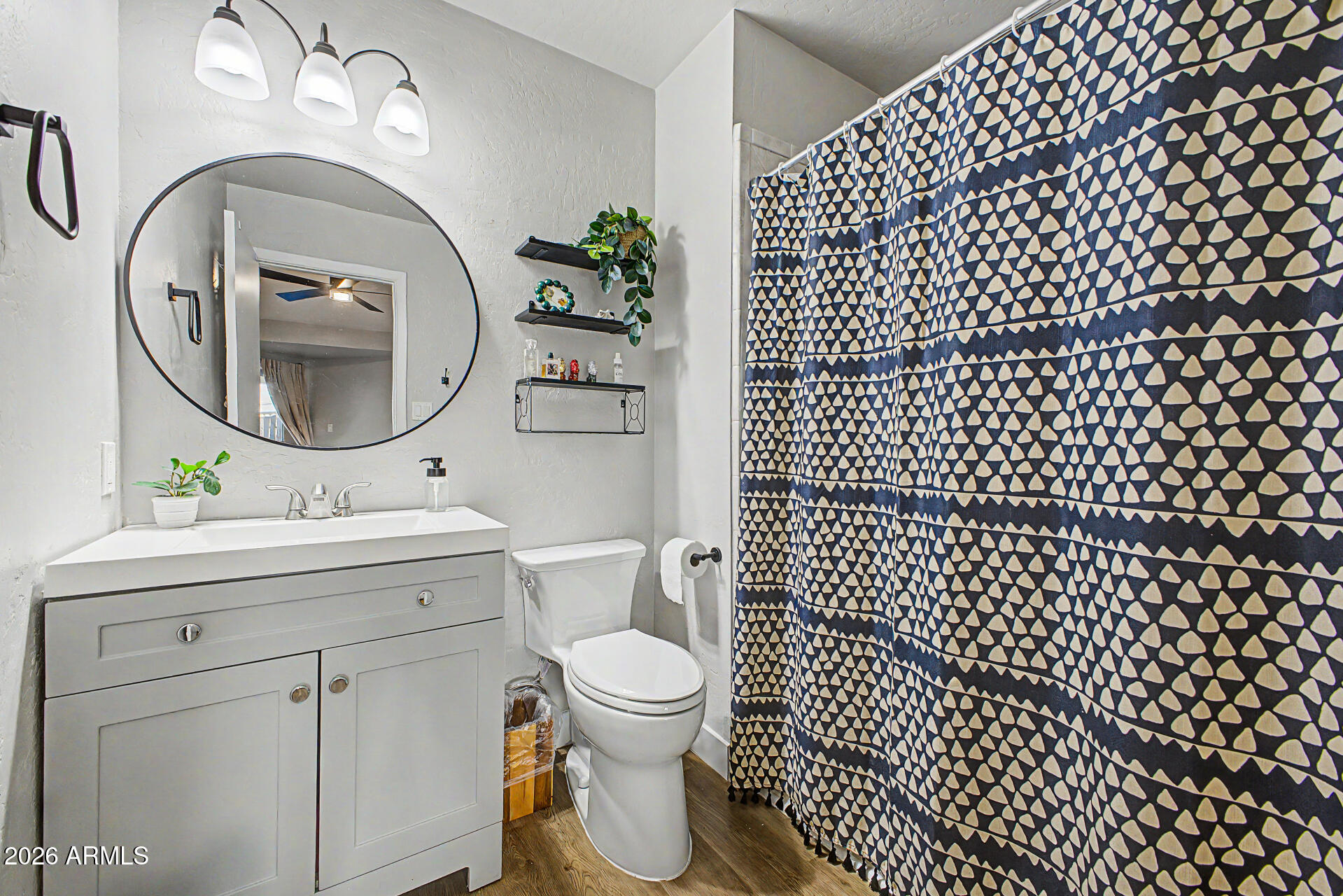 2455 East Broadway Road, Unit 65 Mesa, AZ 85204 - Photo 18 of 36 a bathroom with a toilet sink vanity and mirror