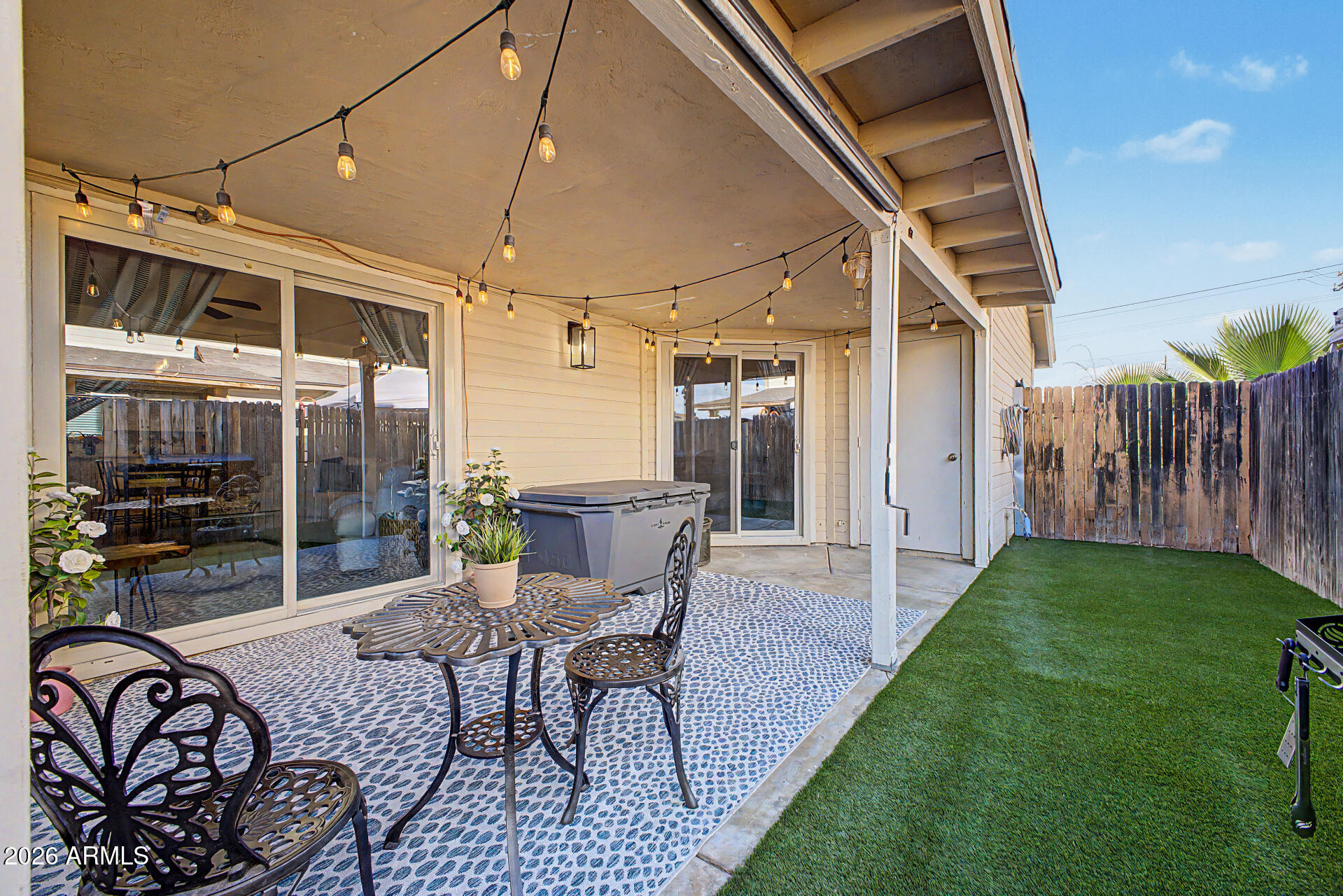 2455 East Broadway Road, Unit 65 Mesa, AZ 85204 - Photo 23 of 36 a patio with yard glass top table and chairs