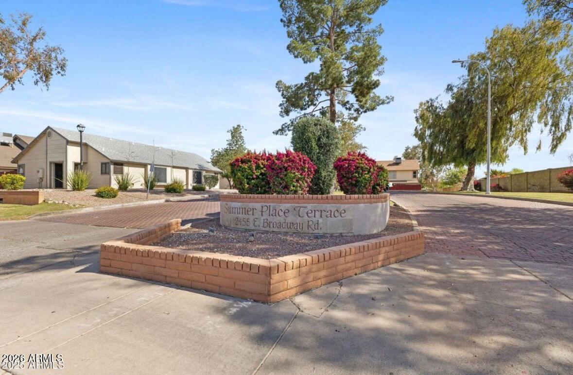 2455 East Broadway Road, Unit 65 Mesa, AZ 85204 - Photo 27 of 36 a view of a white house with a yard
