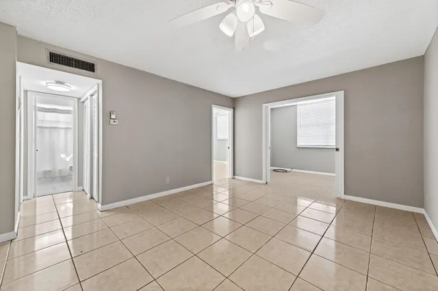 an empty room with kitchen view