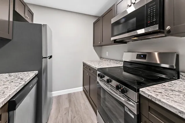 a kitchen with a stove microwave and sink
