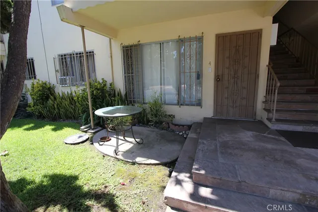 a view of a chairs and table in backyard