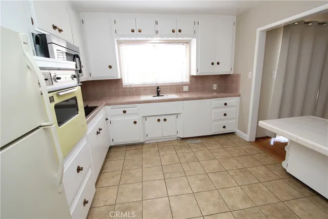 a kitchen with stainless steel appliances a stove a sink and a refrigerator