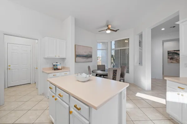 a kitchen with a sink a stove a refrigerator and cabinets
