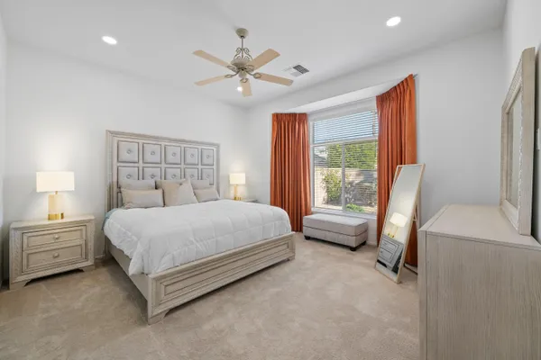 a bedroom with a large bed and a window