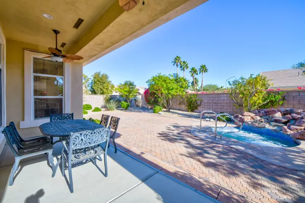 a view of an outdoor dining space with a table and chairs