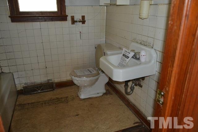 124 Harris Street Roxboro, NC 27573 - Photo 6 of 8 a bathroom with a sink toilet and shower