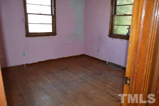 124 Harris Street Roxboro, NC 27573 - Photo 7 of 8 an empty room with windows