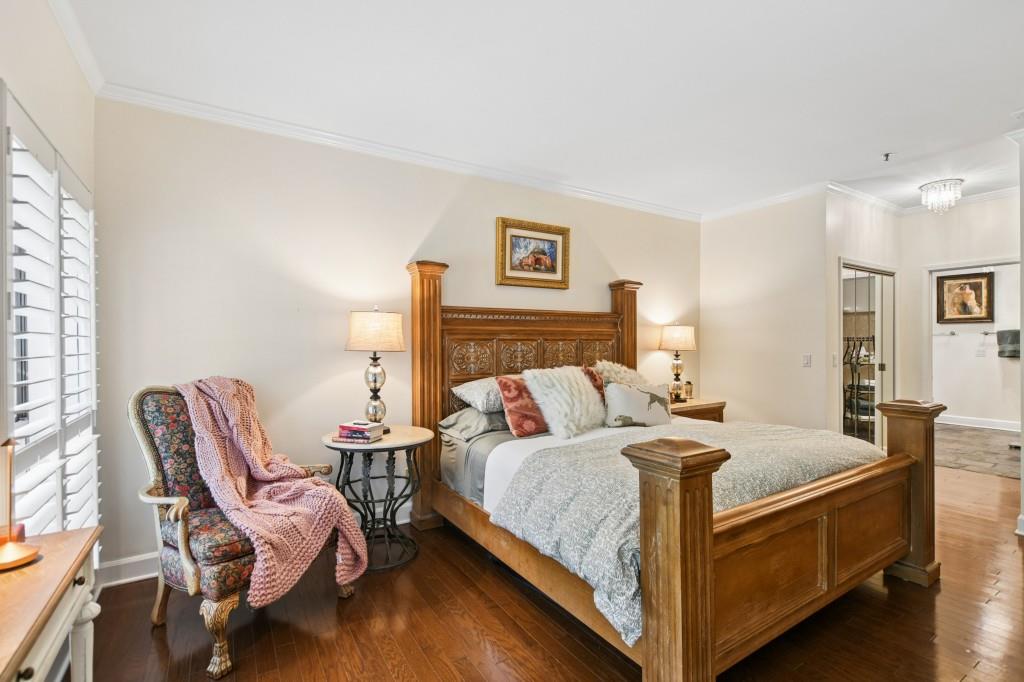 2921 Lenox Road Northeast, Unit 103 Atlanta, GA 30324 - Photo 18 of 37 a bedroom with a bed and wooden floor
