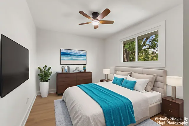 a bedroom with a large bed and a large window