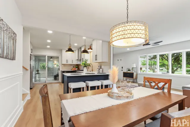 a dining room with furniture a chandelier and window