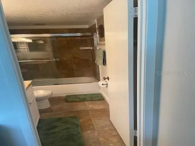 a bathroom with a glass shower door