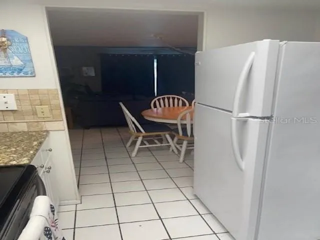 a white refrigerator freezer and a table