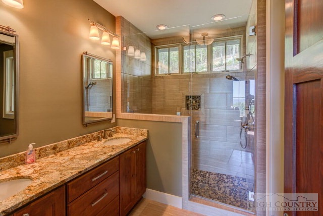 14 Goldenrod Road Boone, NC 28607 - Photo 13 of 16 a bathroom with a granite countertop sink a mirror and a shower
