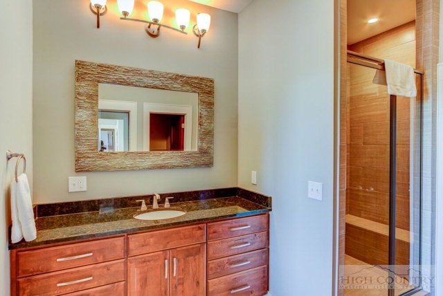 14 Goldenrod Road Boone, NC 28607 - Photo 14 of 16 a bathroom with a granite countertop sink and a mirror