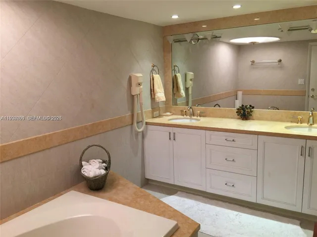 a spacious bathroom with a double vanity sink and a mirror