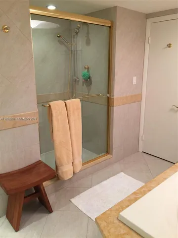 a bathroom with a bathtub and a shower