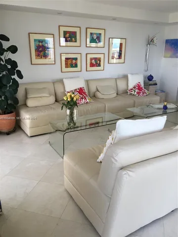 a living room with furniture and flowers