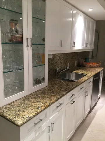 a kitchen with sink and cabinets