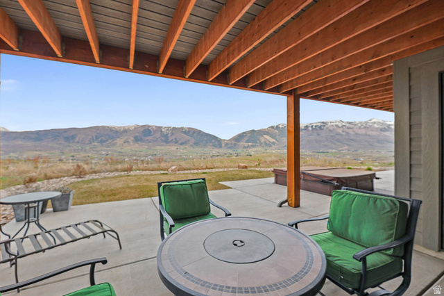 4527 North Seven Bridges Road Eden, UT 84310 - Photo 53 of 65 View of patio / terrace with a hot tub and a mountain view