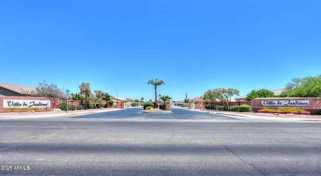 a view of a street with cars and a houses