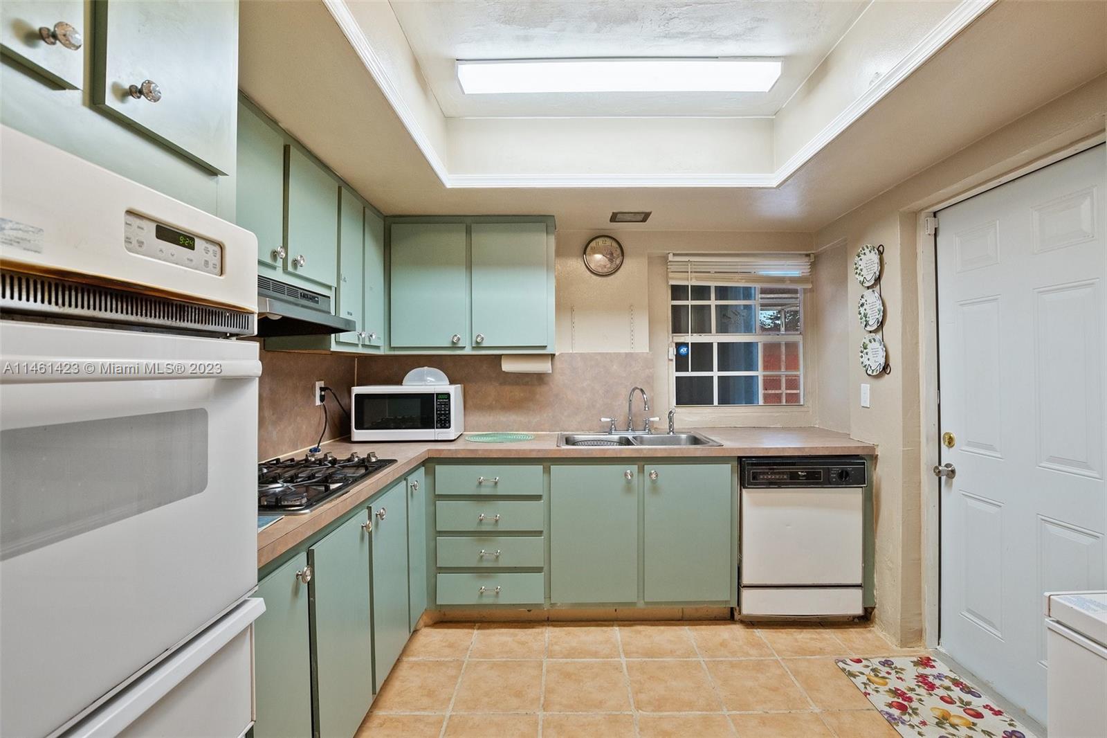 3405 East Shore Road Miramar, FL 33023 - Photo 11 of 25 a kitchen with stainless steel appliances a stove sink and cabinets