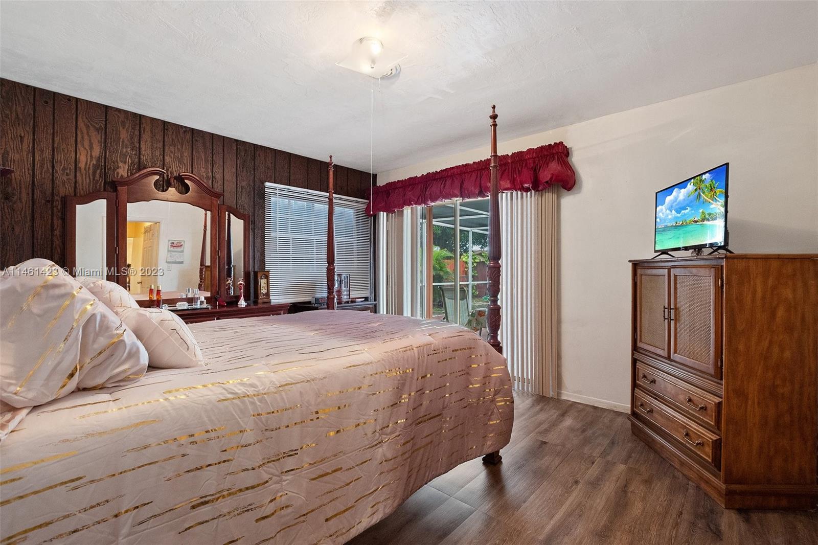 3405 East Shore Road Miramar, FL 33023 - Photo 13 of 25 a bedroom with a bed dresser and a window