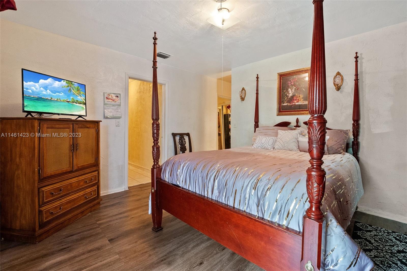 3405 East Shore Road Miramar, FL 33023 - Photo 14 of 25 a bedroom with a bed and a flat screen tv