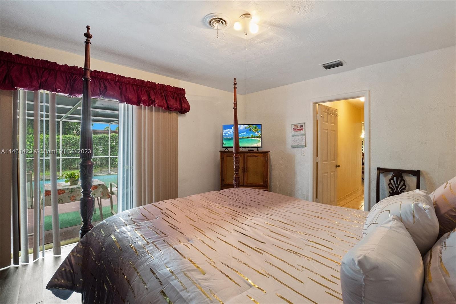 3405 East Shore Road Miramar, FL 33023 - Photo 15 of 25 a bedroom with a bed window and cabinet